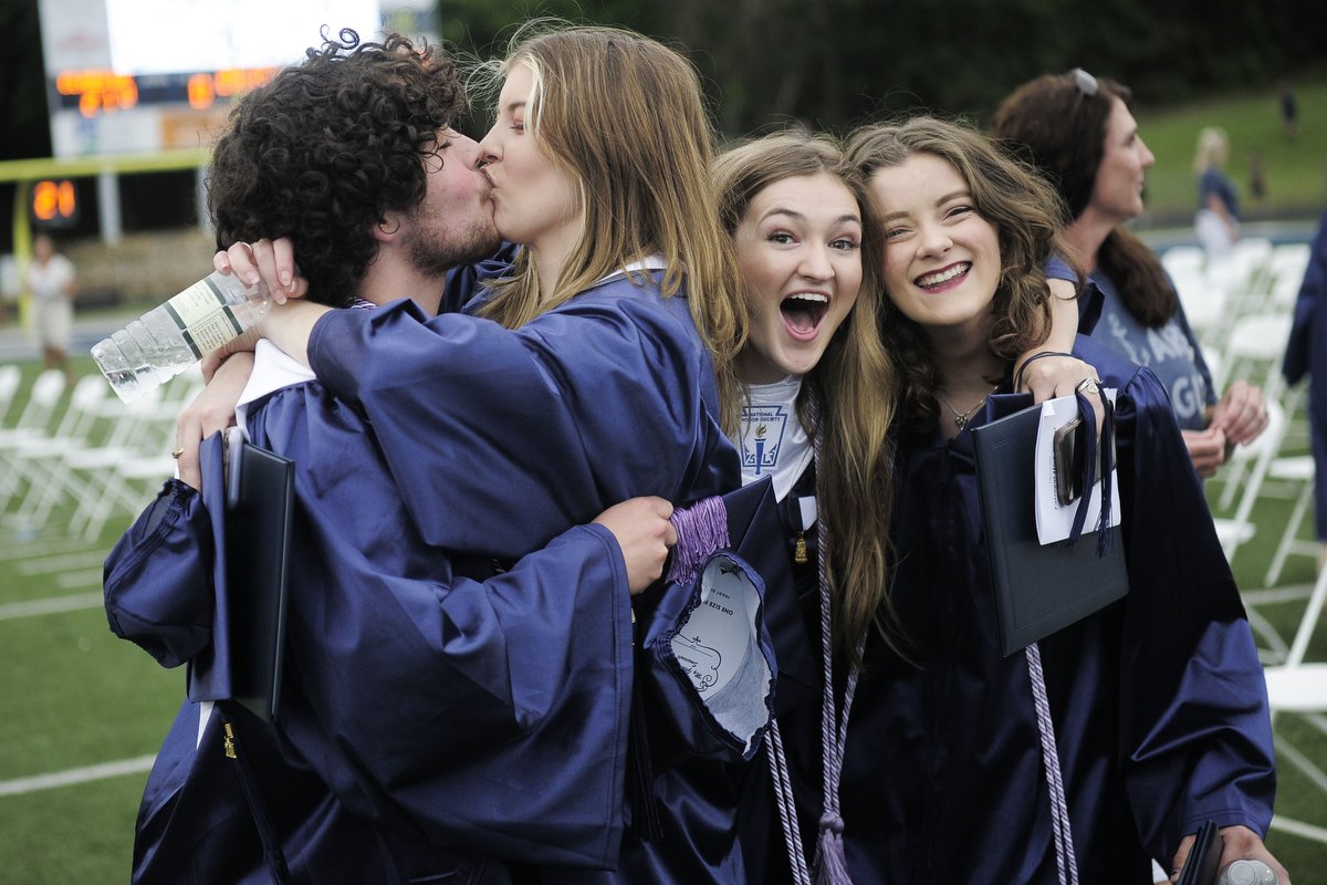  A couple shares a kiss during their graduation ceremony at Farragut High School in Farragut, Tenn. 