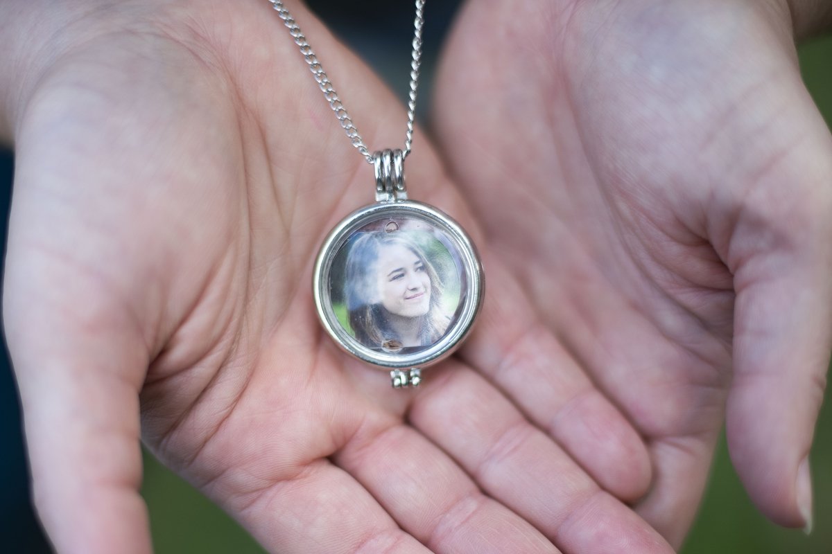  Melissa Eimers wears a locket of her daughter Hannah Eimers' senior portrait from 2015 around her neck. Hannah was killed in 2016 when her car struck a guardrail that did not properly react when hit, instead impaling her car. The faulty guardrails h