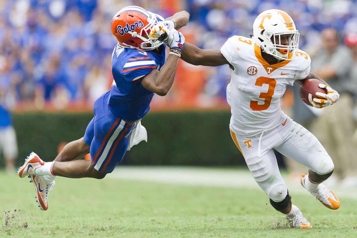  Tennessee running back Ty Chandler (3) pushes away Florida cornerback Marco Wilson (3) as he runs the ball down the field at Ben Hill Griffin Stadium in Gainesville. 