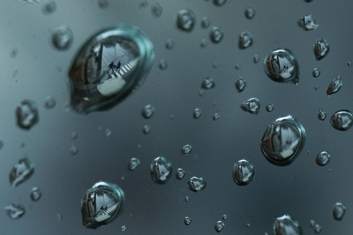  Refracted within water droplets, pedestrians cross Clinch Ave. and Locust St. during an afternoon rainstorm in Knoxville on Tuesday, Feb. 12, 2019. 