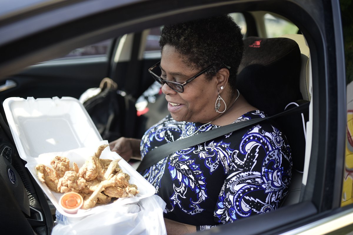  Pamela Harrison ordered 10 wings on this visit to Burger Boys restaurant. She typically orders 20 at a time. She sometimes skips breakfast to save room for the food, which she enjoys eating with hot sauce on the drive home. 