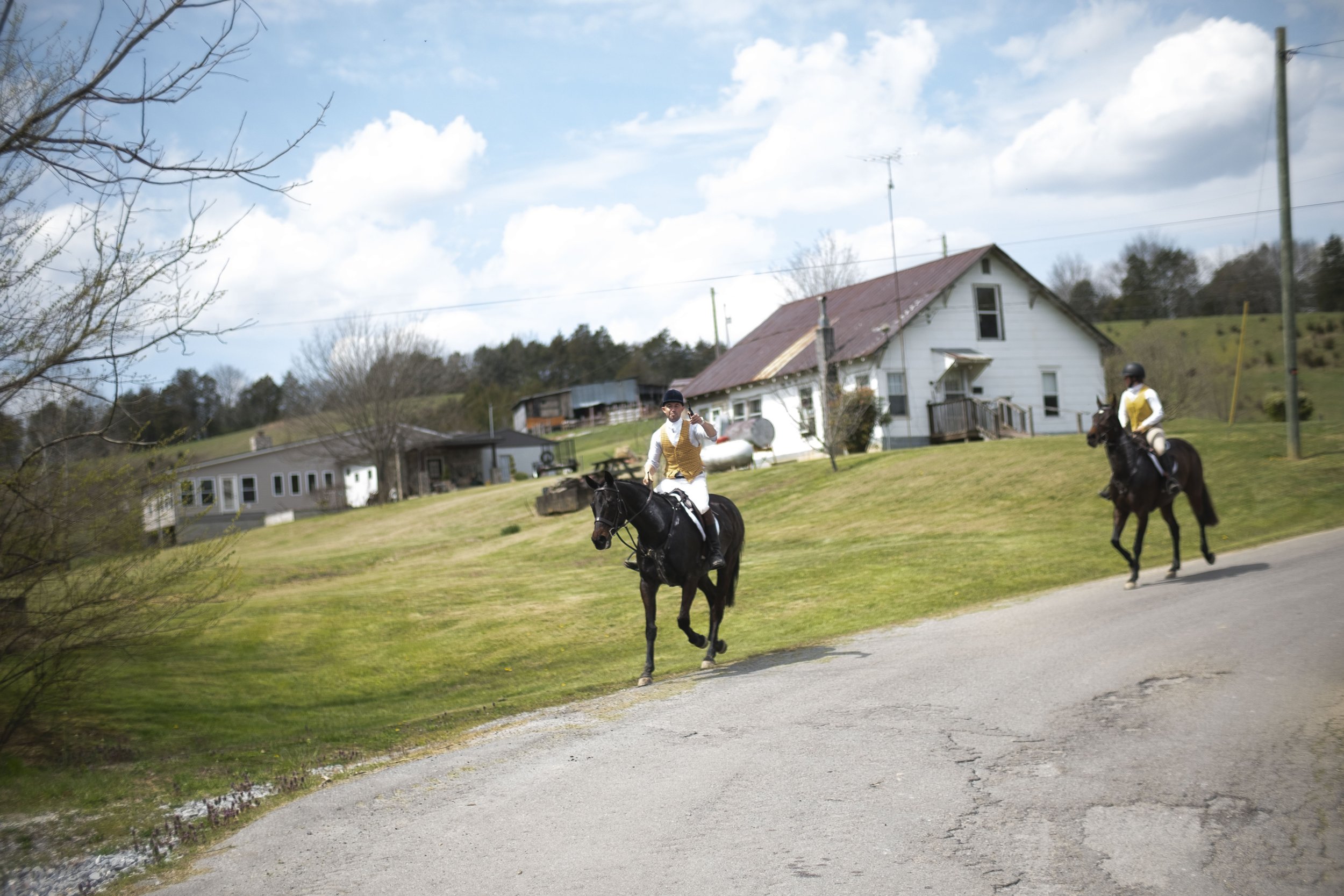  TVH Master Huntsman Ryan Johnsey and Marley Spears, 15, gallop down a rural road during a fixture in Greeneville, Tennessee. 