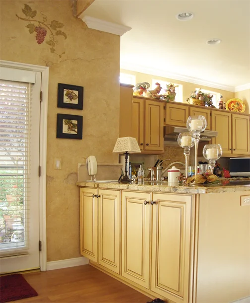 Faux distressed stone wall finish with hand painted grapevines. 