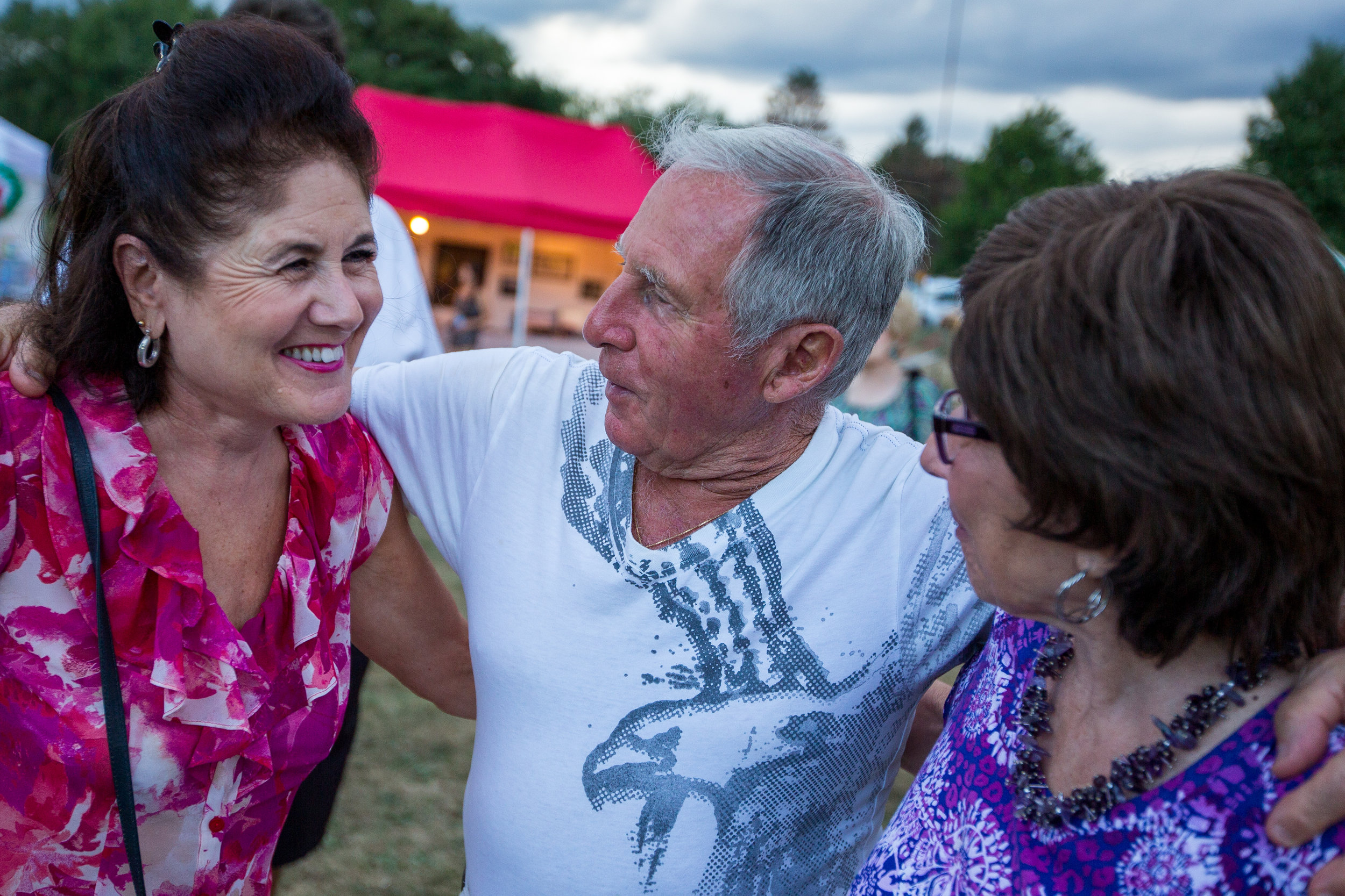  Henry Bufalini, center, hugs Carol Fox, left and Jeanne Smith at the 91st San Rocco Festa in Aliquippa on Saturday afternoon. The festival, which originated in the town of Patrica, Italy, took place over three days and featured live music, vendors, 