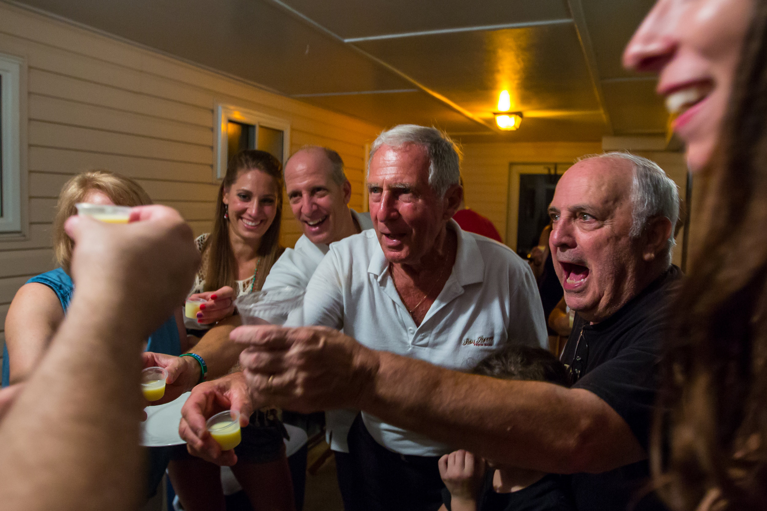  Henry Bufalini, center, raises a shot of limoncello at a close friends house after the first night of the 91st San Rocco Festa in Aliquippa on Friday. Each year after the first night of the festival, family and close friends go to multiple houses to