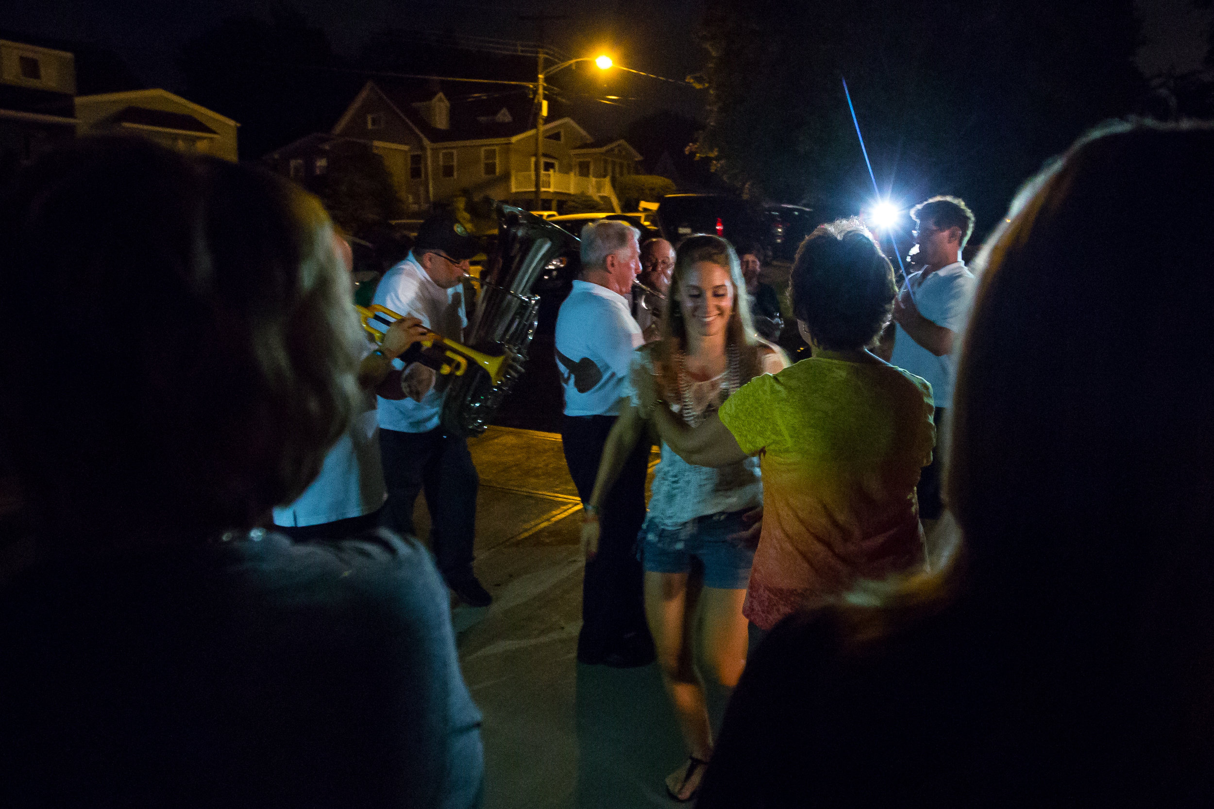  Natalee Bufalini, granddaughter of Henry, center, dances with Grace Tisch while the Ballabe band plays in the background in Aliquippa on Friday evening. Each year after the first night of the festival, the Ballabe band goes to multiple houses to pla