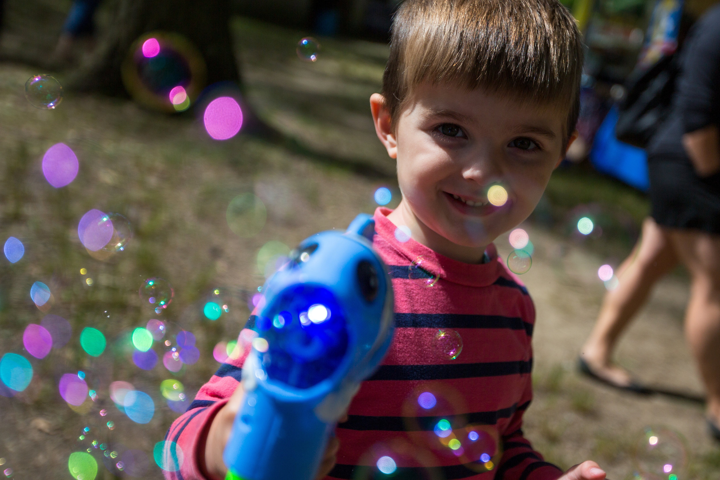  Benson Puff, 3, plays with a bubble machine at the Ellwood City Arts Festival at Ewing Park on Saturday morning.  
