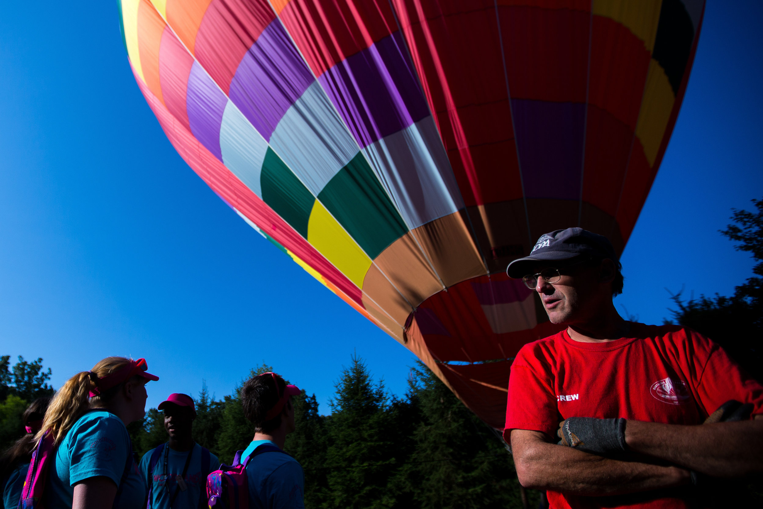  John Royer, of Nostalgia Ballooning from the Chicago area, watches and he and partner Chad Morin wait for steady winds so they can take kids from Camp Inspire on rides at the Woodlands Foundation on Tuesday morning. Nostalgia Ballooning drove to Wex