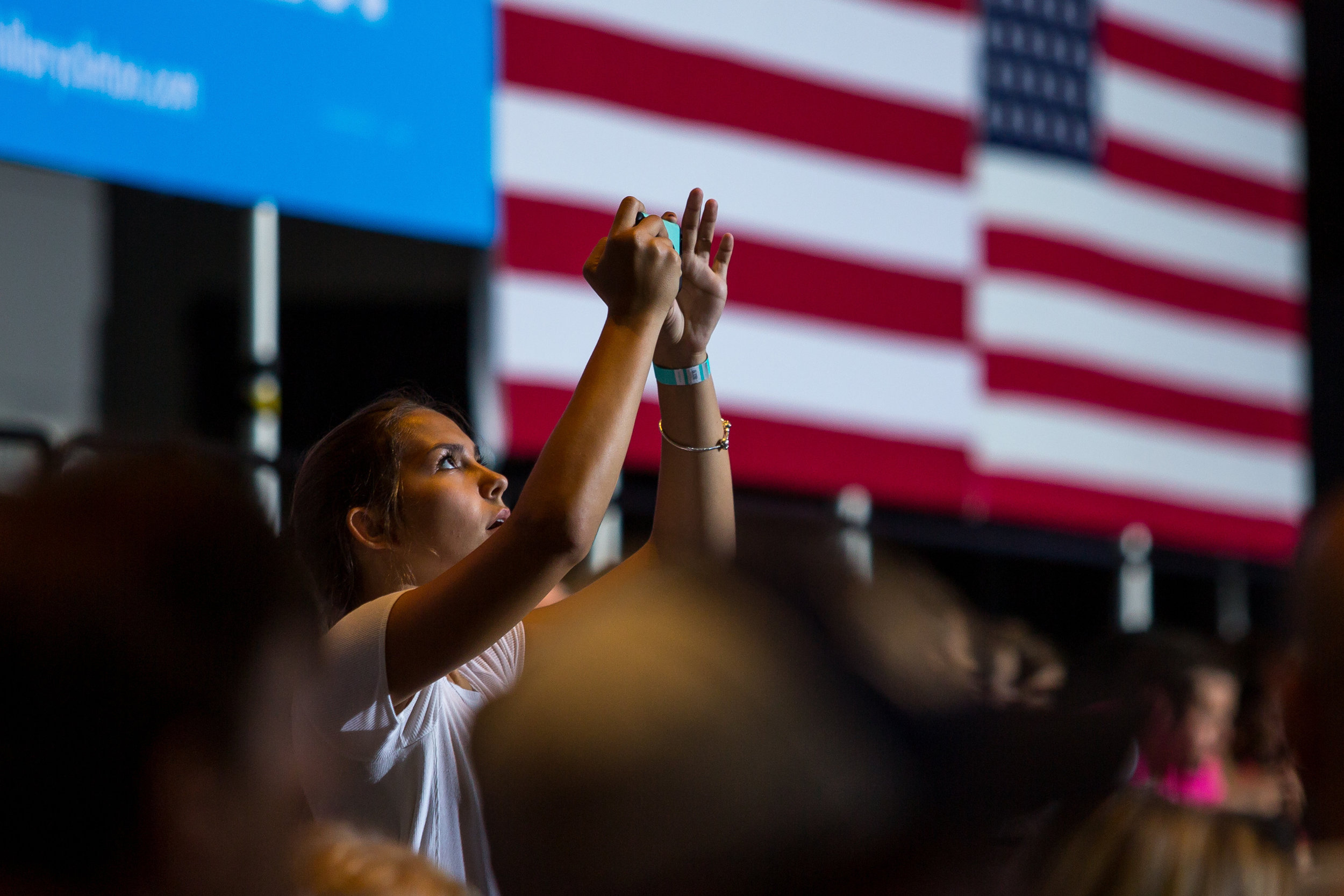  A girls takes a photo on her phone before the beginning of the Hillary Clinton and Tim Kaine rally at the David L. Lawrence Convention Center on Saturday evening. Clinton has clenched the democratic nomination and is the first major party female nom