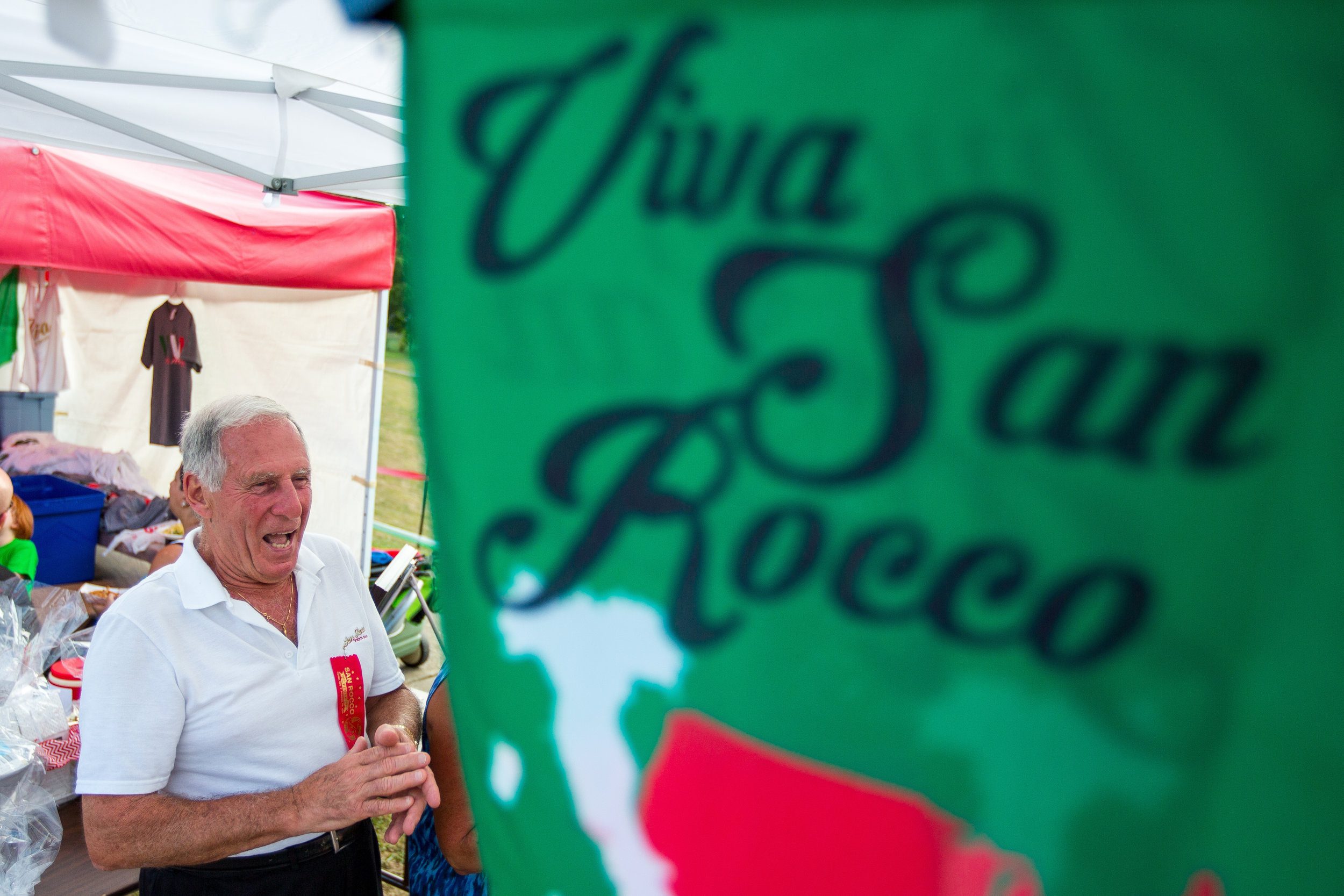  Henry Bufalini talks to friends at the 91st San Rocco Festa in Aliquippa on Friday afternoon. The festival took place over three days and featured live music, vendors, fireworks, a mass and the traditional Baby Doll Dance on Sunday evening.  