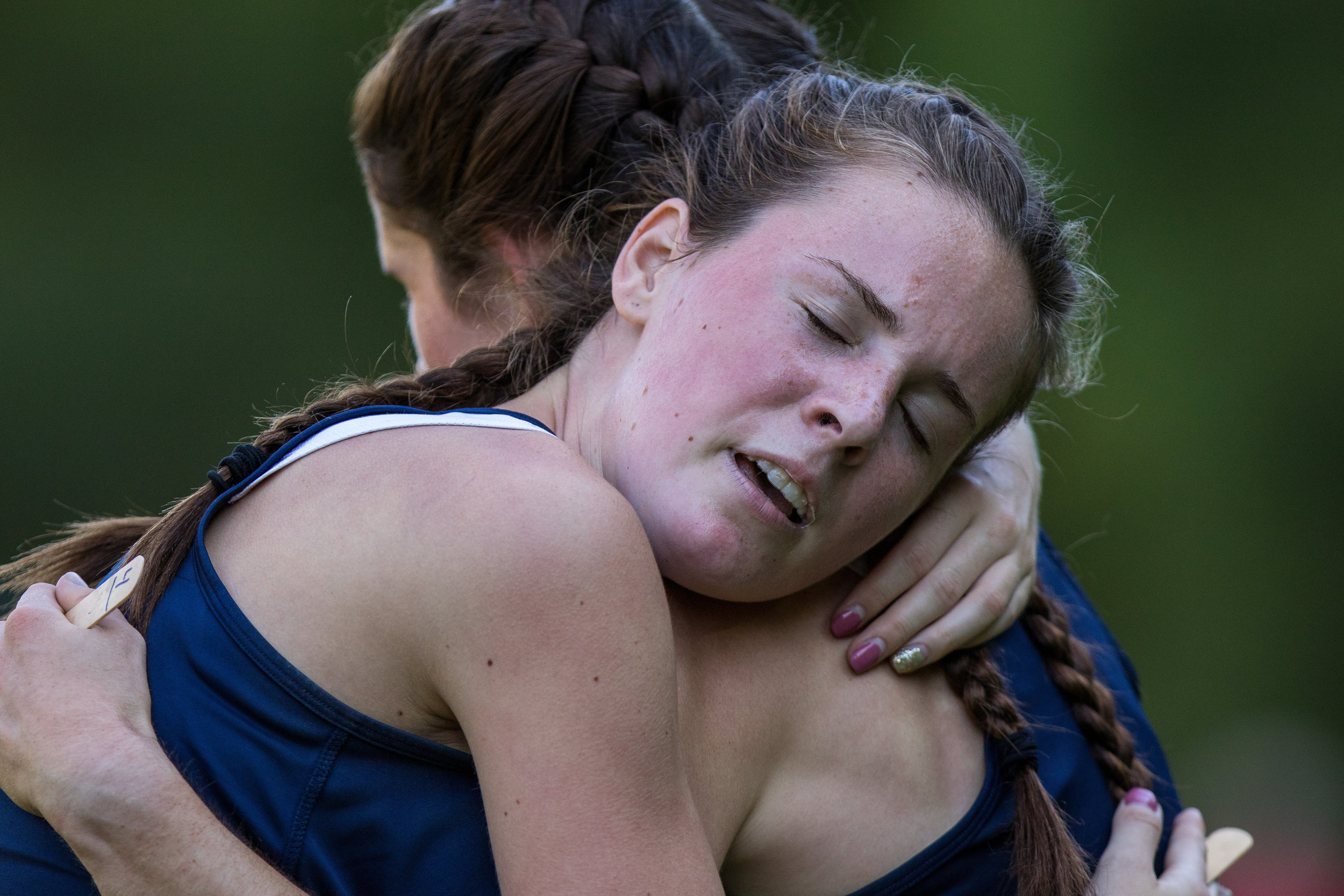  Lauren McCoy, right and Carinna Lapson both of Hopewell High School embrace after they both crossed the finish line of the women cross county meet at Hopewell Community Park on Tuesday afternoon. McCoy and Lapson won third and fourth place, with tim