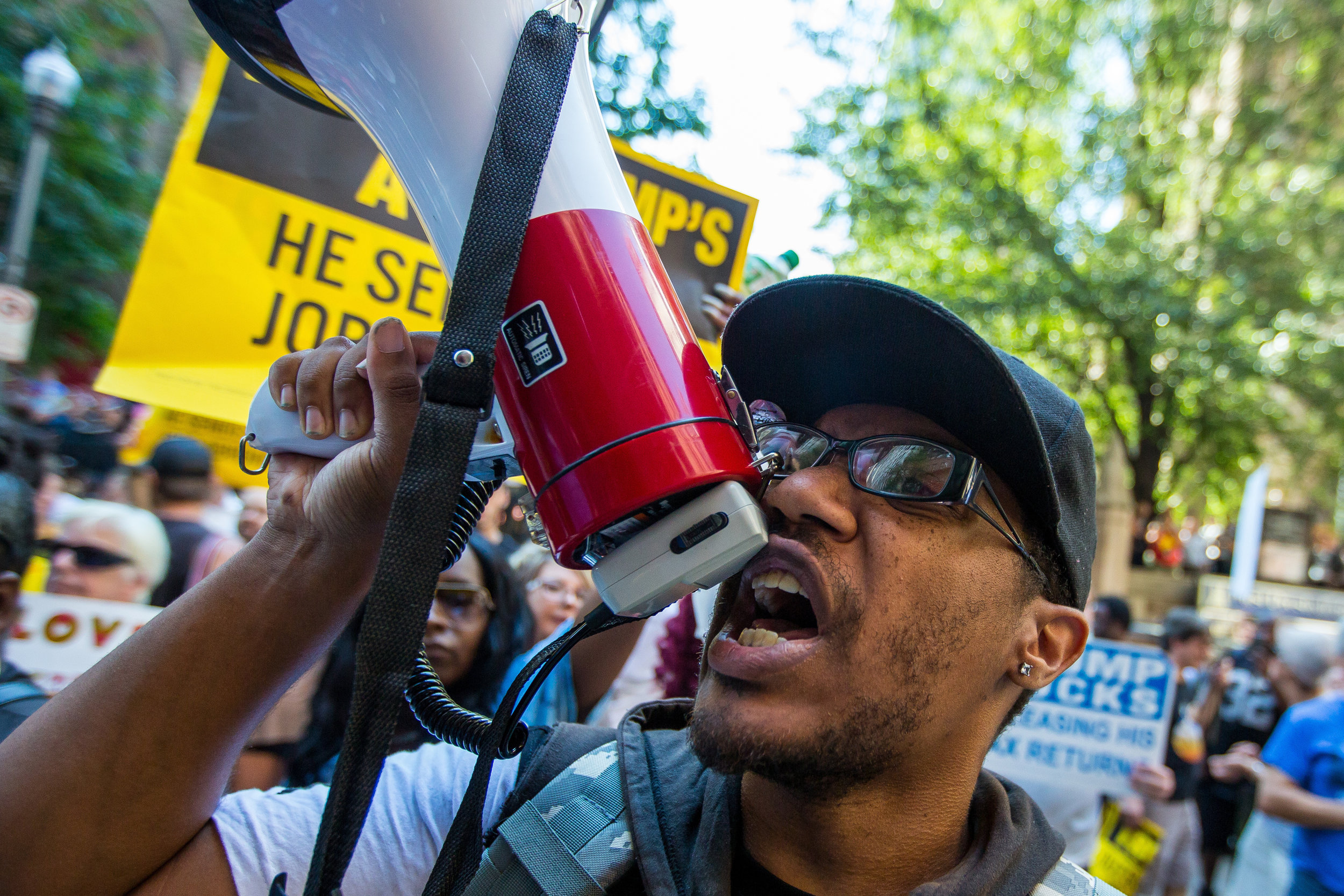  Chris Ellix, of Northside, yells into a megaphone while protesting outside of the Duquesne Club on Sixth Ave. in Pittsburgh on Thursday afternoon. The protest took place after Republican Presidential nominee Donald Trump had lunch at the Duquesne Cl