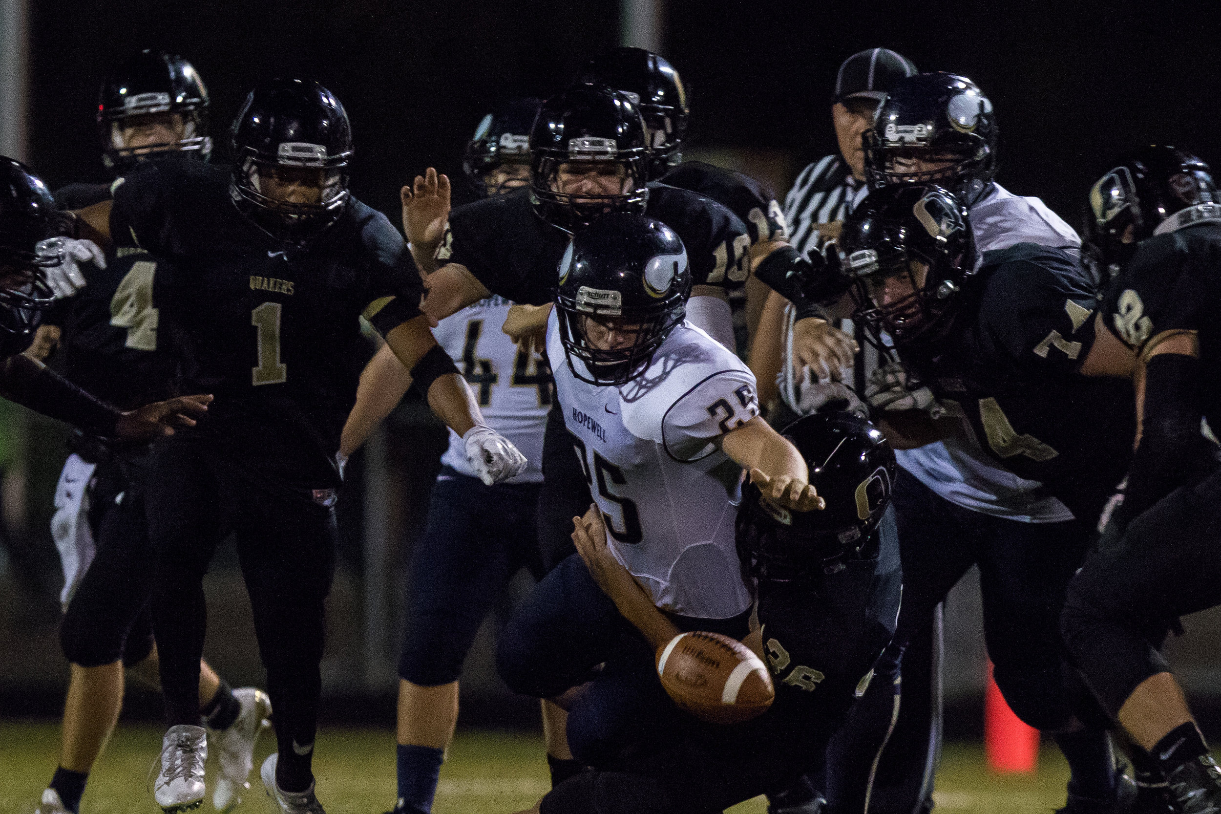  Hopewell's Daniel Wes Smith, 25 and Quaker Valley defenders all reach for a fumble caused by Quaker Valley during the second half of play at Quaker Valley on Friday evening. Quaker Valley beat Hopewell at home 31-14.  