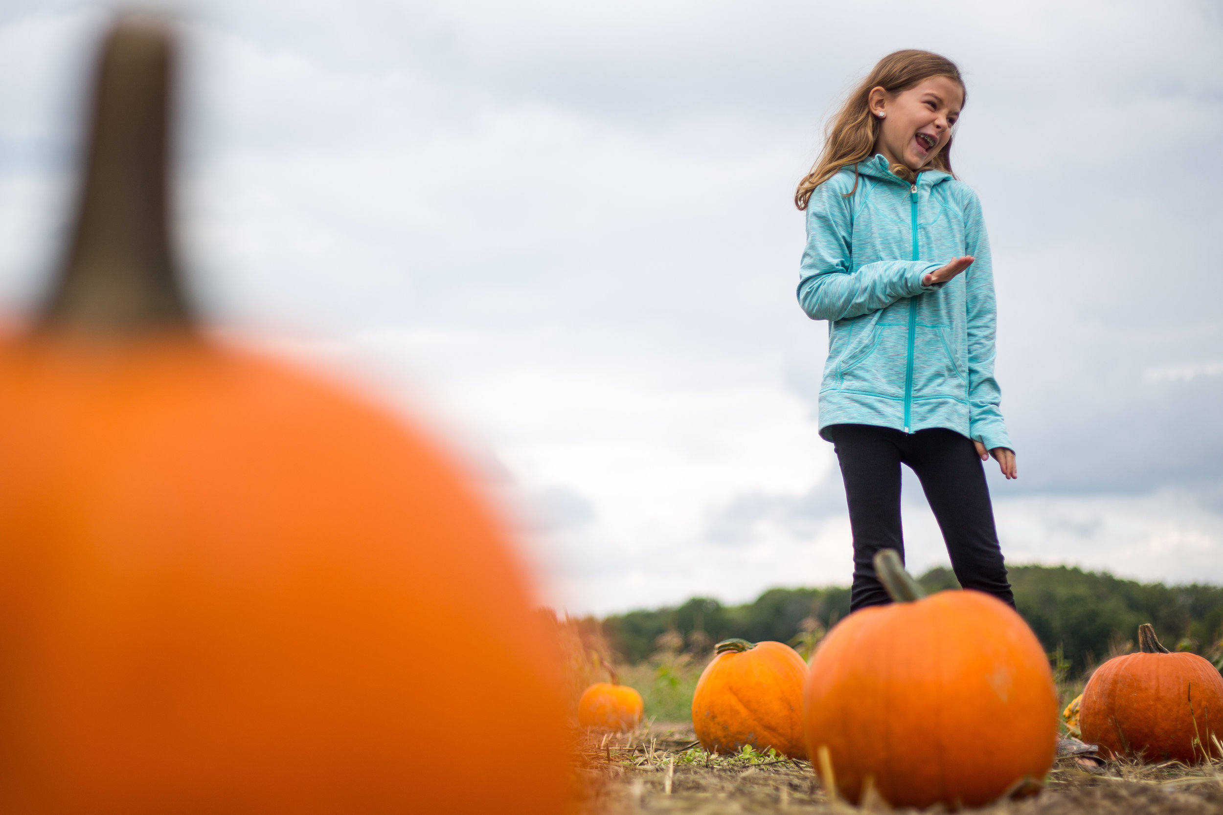  Ayla Sterner, 8, laughs as she finds the perfect pumpkin at Wise Farm in North Sweickley on Sunday afternoon.  