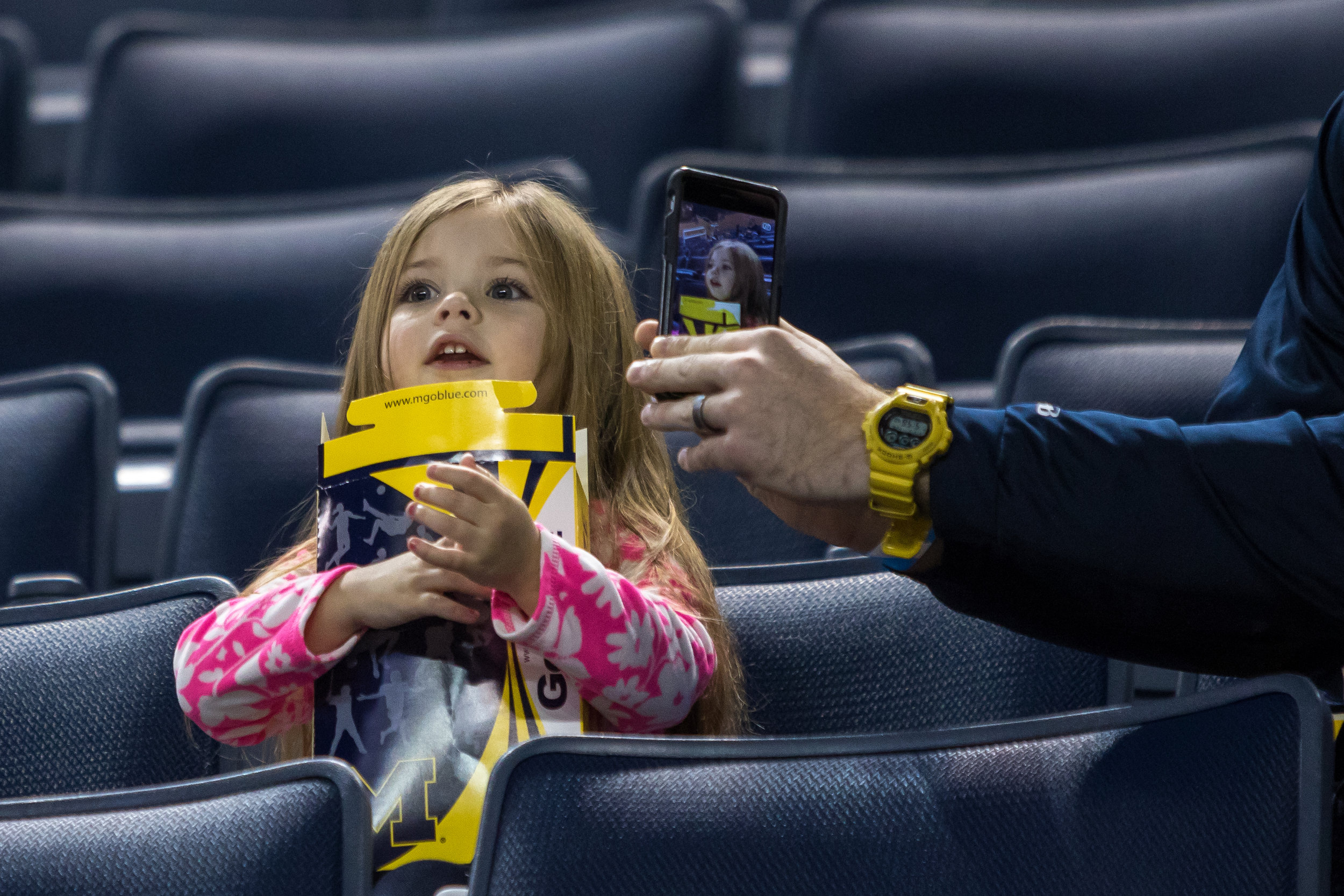  Dirk Roberts takes a photograph of his daughter Ava, 3, before tipoff between Michigan and Mount St. Mary's at the Crisler Center on Saturday, November 26, 2016. Matt Weigand | The Ann Arbor News 