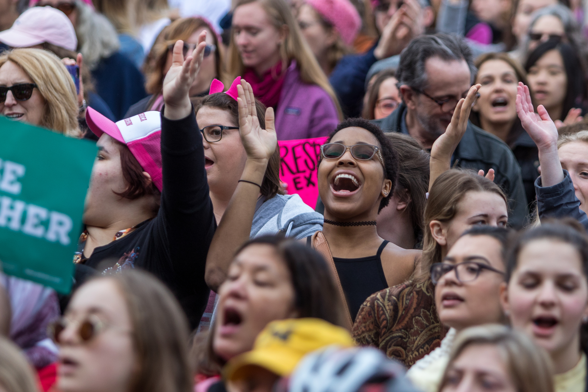  A woman sings at the Diag at the University of Michigan during the Women's March on Saturday, January 21, 2017.  The march was one of several throughout the country and drew over 6,000 people. Matt Weigand | The Ann Arbor News 