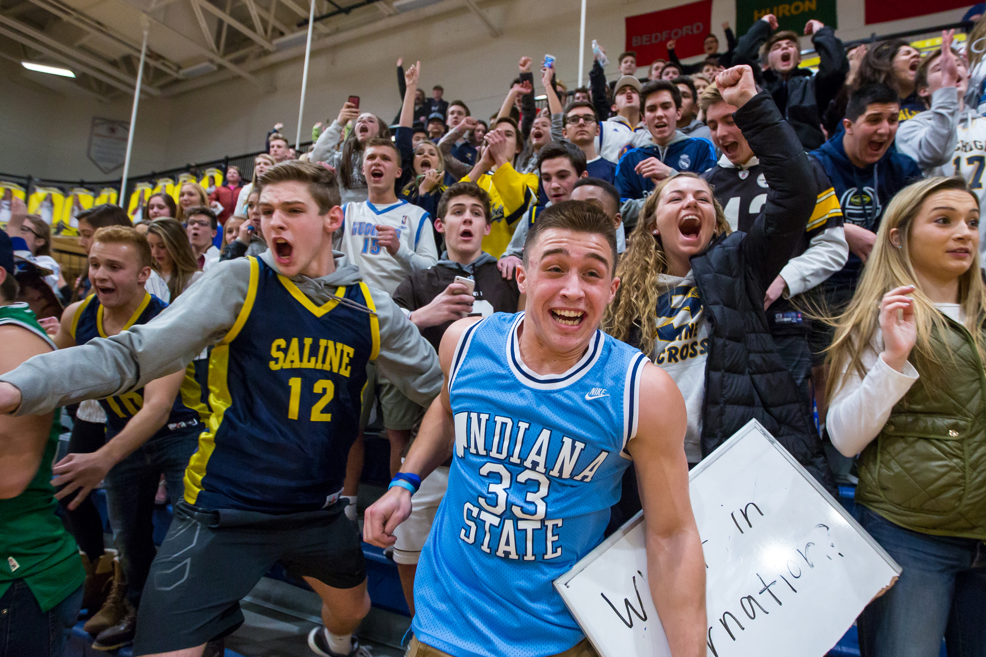  Saline High School senior Zach Schwartzenborgen, center, runs onto the court with fellow classmates after Saline beat Ann Arbor Huron at Saline High School on Friday, January 20, 2017. Matt Weigand | The Ann Arbor News 