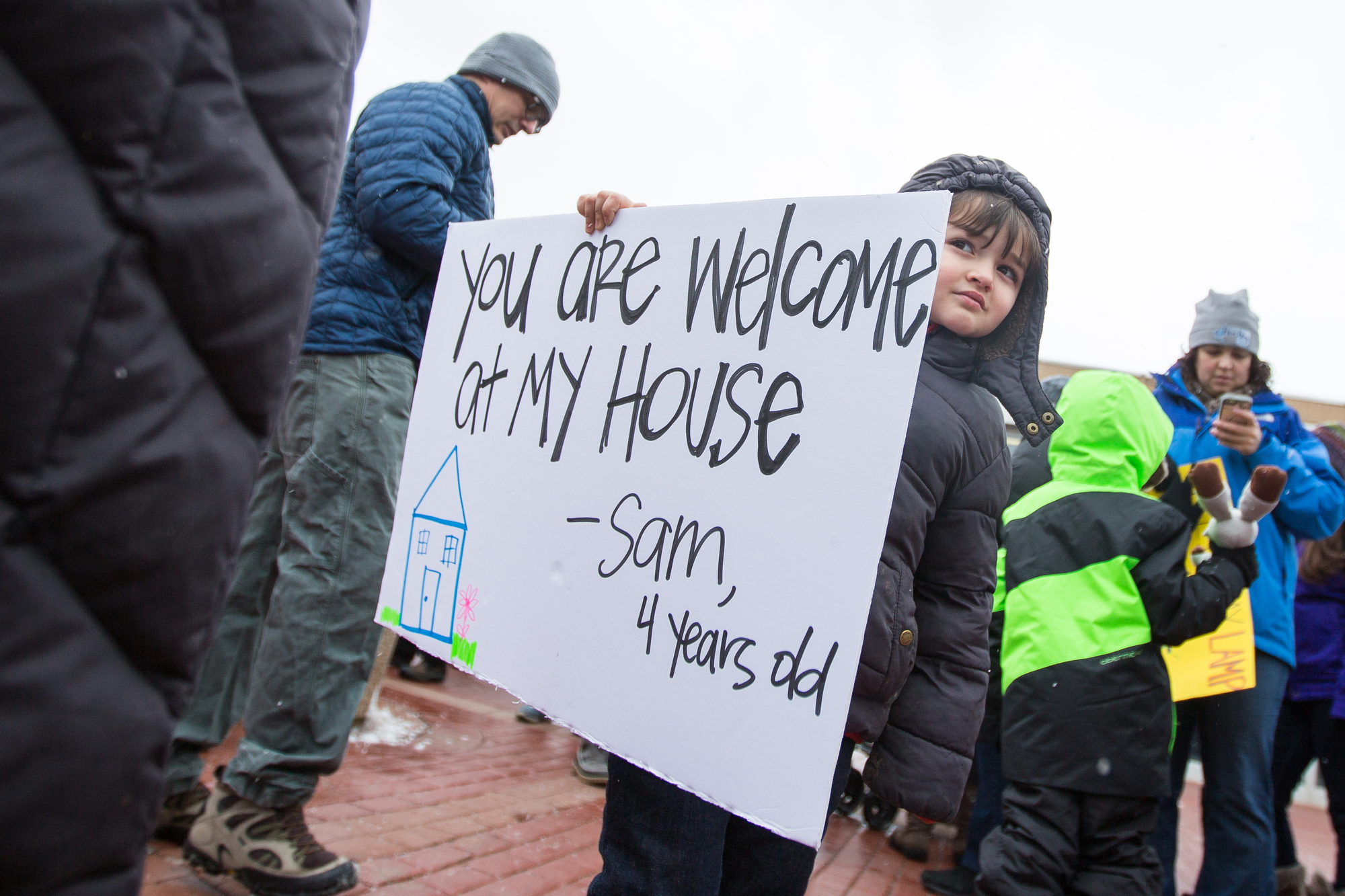  Sam Sussman, 4, holds a sign while attending an anti-immigration protest outside of the Federal Building in downtown Ann Arbor on Sunday, January 29, 2017. About 100 people attended the protest. Matt Weigand | The Ann Arbor News 