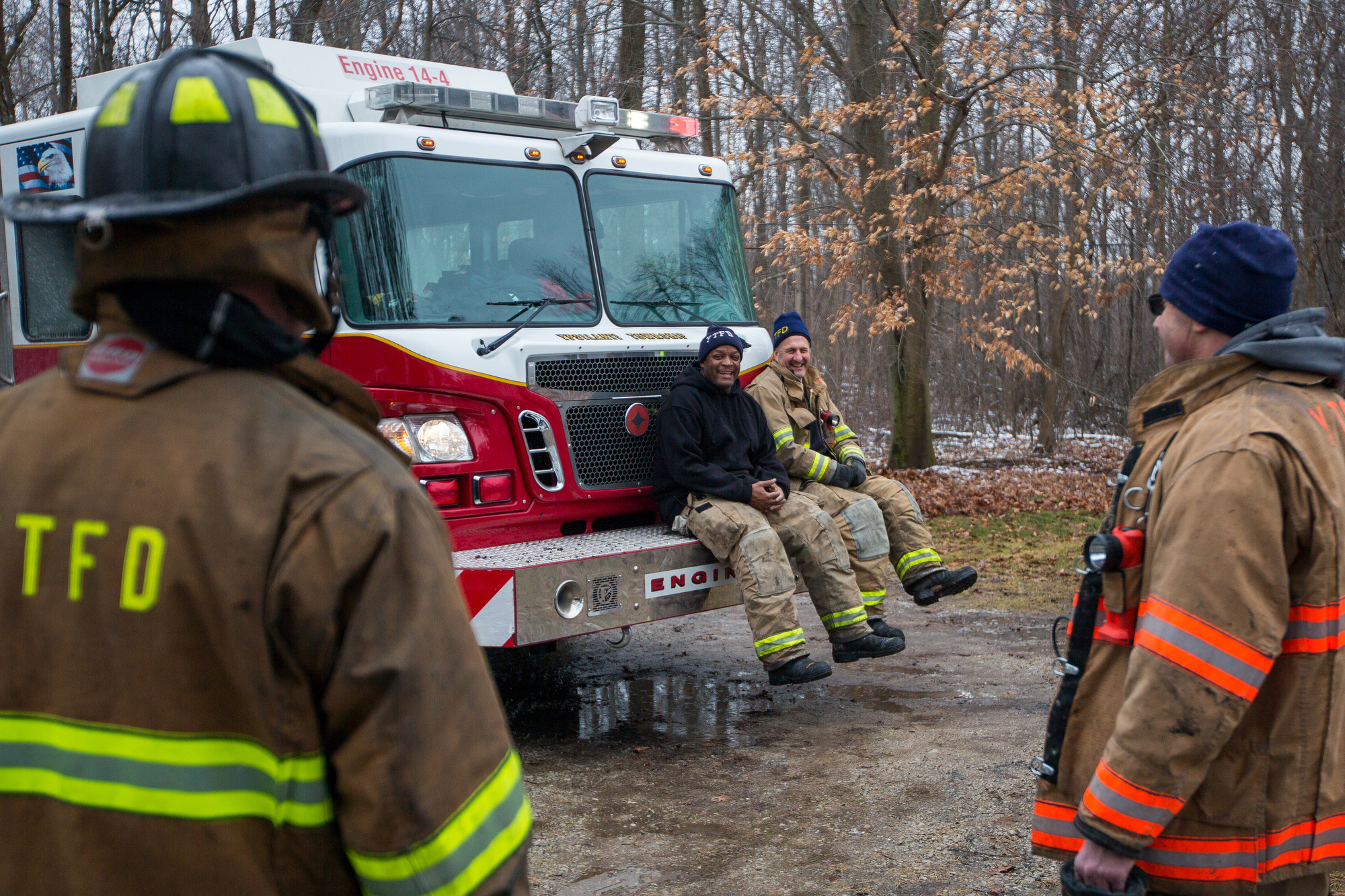  Two members of the Ypsilanti Township Fire Department sit on the front bumper of a fire truck after extinguishing a house fire at 9525 East Bemis Road in Ypsilanti Township on Sunday, January 29, 2017. The fire, which is still under investigation, w
