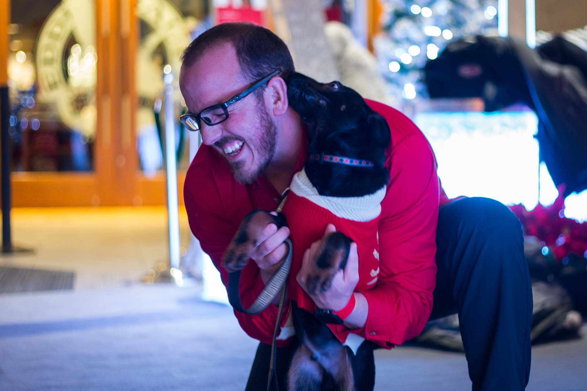  Briarwood Mall employee Jonathan Knight plays with Stanley, a 3-month-old German Shepherd mix, before taking a picture with santa at Briarwood Mall on Sunday, December 11, 2016. Each year Briarwood Mall hosts two nights where people can bring their 