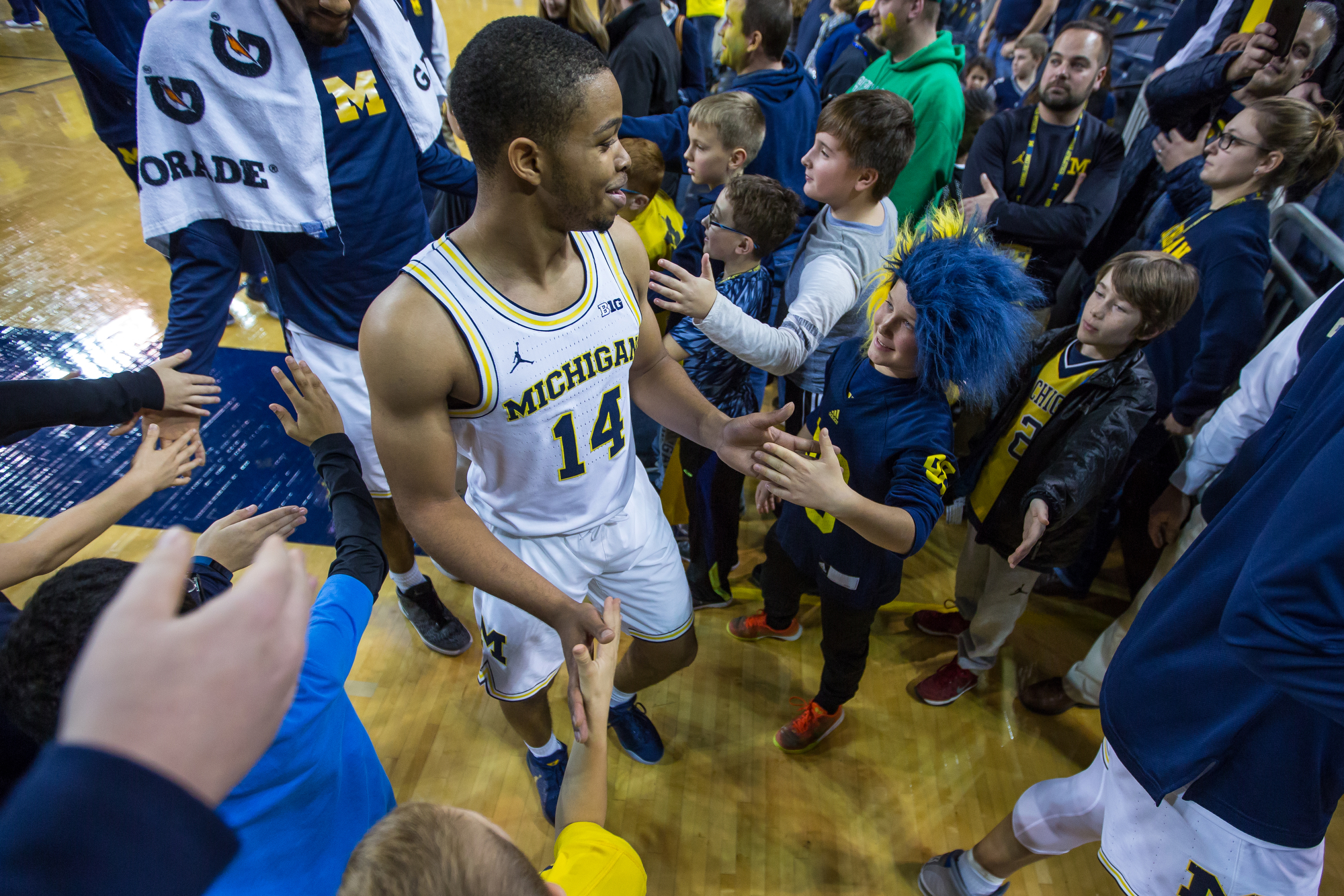  Michigan�s Fred Wright-Jones (14) shakes hands with young fans after the completion of play at the Crisler Center on Saturday, December 17, 2016. The Michigan Wolverines beat the Maryland Eastern Shore Hawks 98-49. Matt Weigand | The Ann Arbor News 