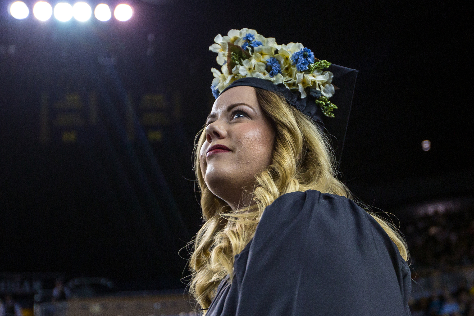 A graduating student looks un into the crowd to locate her family before walking onto stage during the University of Michigan winter commencement at the Crisler Arena on Sunday, December 18, 2016. About 1,000 other students graduated at the Crisler 