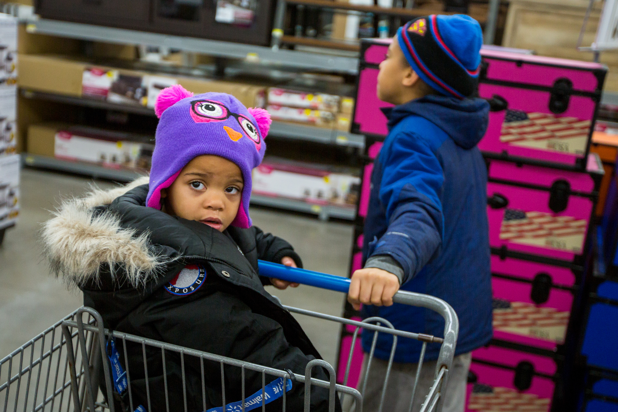  Ta'Nya Phelan, 3, right, sits in  shopping cart while her brother, Juwone Phelan, 12, pushes her while at a shopping trip sponsored by the Warm the Children fund at Walmart in Saline on Friday, December 23, 2016. The Warm the Children fund gathers d