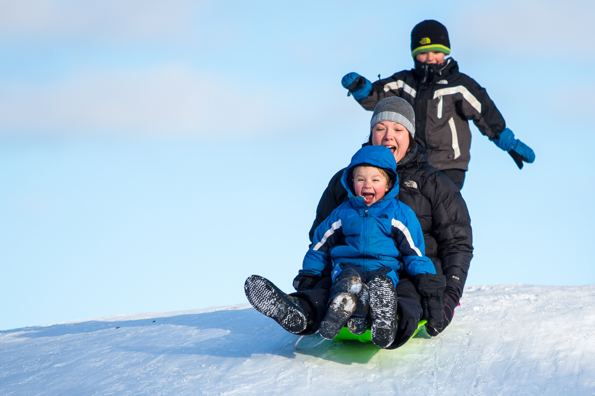  Jessica Anderson, center, sleds down a hill at Burt Park with her son Jude, 4 and help from her other son Liam, 6, on Thursday, February 2, 2017. Matt Weigand | The Ann Arbor News 