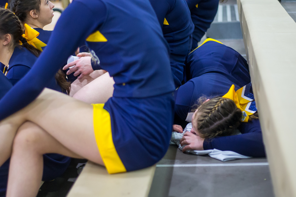  Margie Raupp, Saline High School freshman, lays down after not feeling well after the third round of the 2017 Dexter Competitive Cheer Invitational at Dexter High School on Saturday, February 11, 2017. The Saline team got first place with an overall