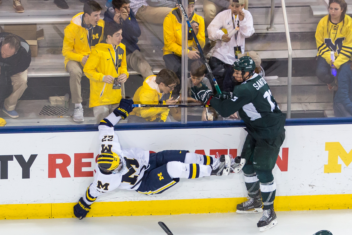  Michigan's Nicholas Boka (27) is thrown into the wall during the matchup against Michigan State at Yost Ice Arena on Saturday, February 11, 2017. The Michigan State Spartans beat the University of Michigan Wolverines 4-1. Matt Weigand | The Ann Arbo