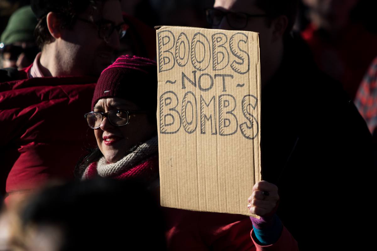  A woman holds a sign during the women's strike and gathering at Liberty Plaza on Wednesday, March 8, 2017. The march was part of an international gathering and movement for women's rights. Matt Weigand | The Ann Arbor News 