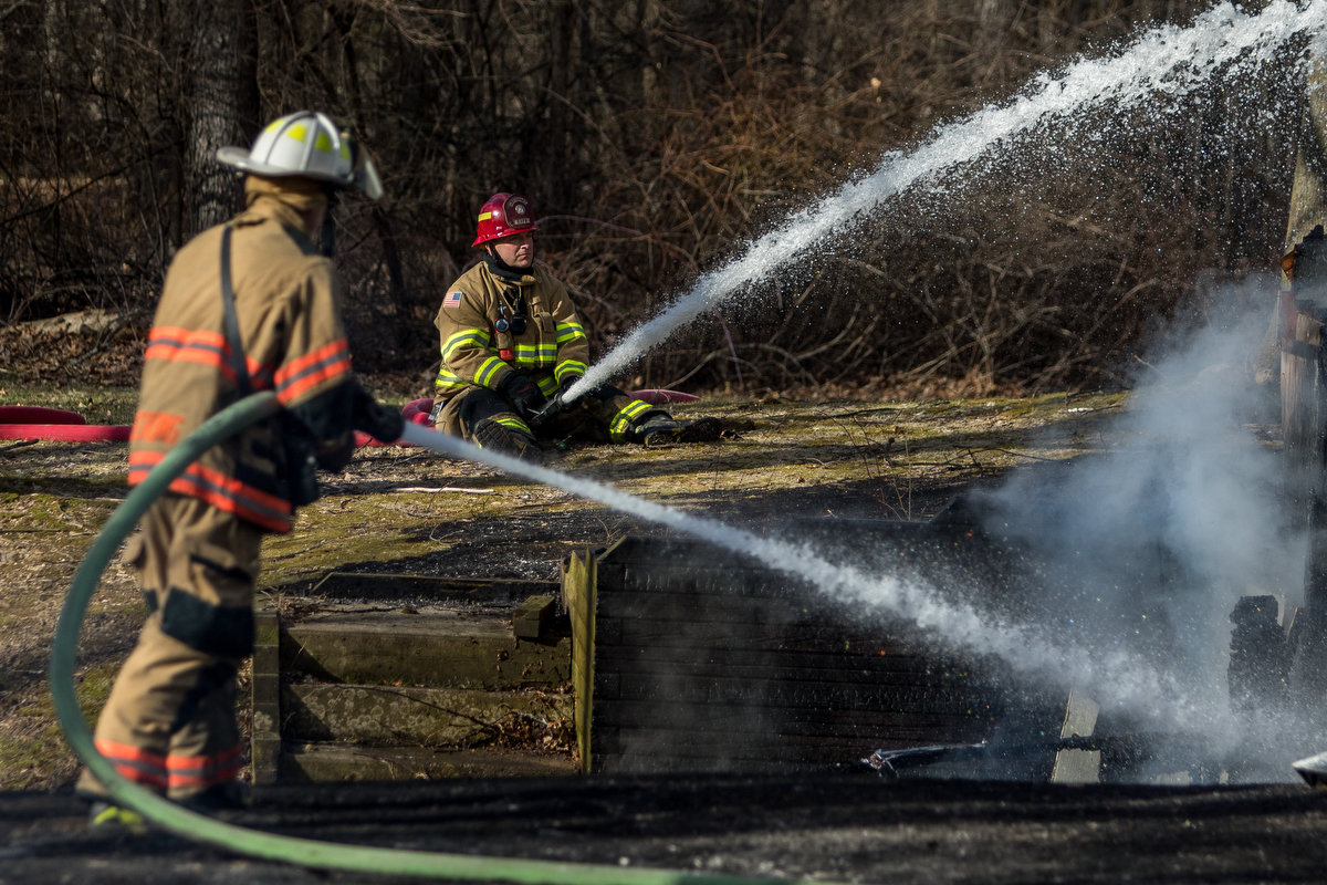  Two fire fighters work to extinguish a structure fire on Scully Road in Webster Township on Friday, March 10, 2017. The fire completely destroyed the home and a nearby field caught on fire. The cause of the fire is still under investigation. Matt We