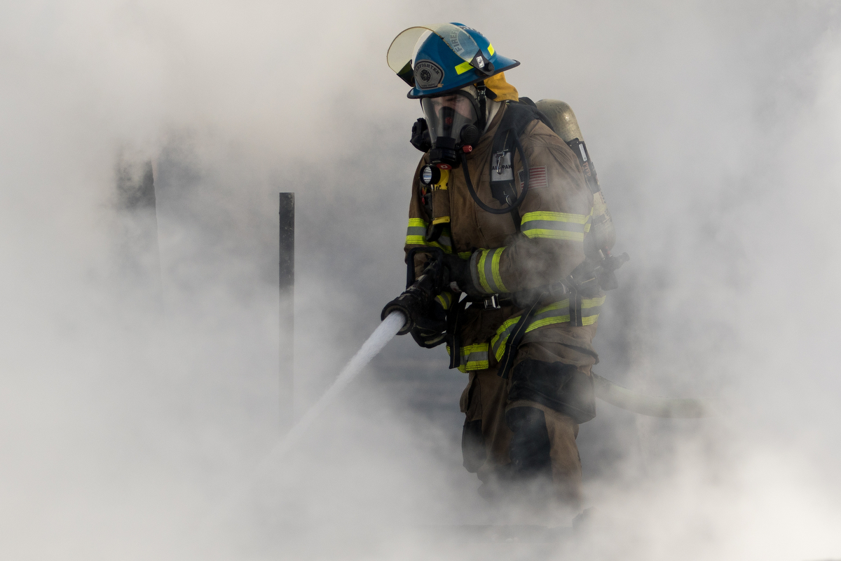  A fire fighter is engulfed in smoke as he works to extinguish a structure fire on Scully Road in Webster Township on Friday, March 10, 2017. The fire completely destroyed the home and a nearby field caught on fire. The cause of the fire is still und