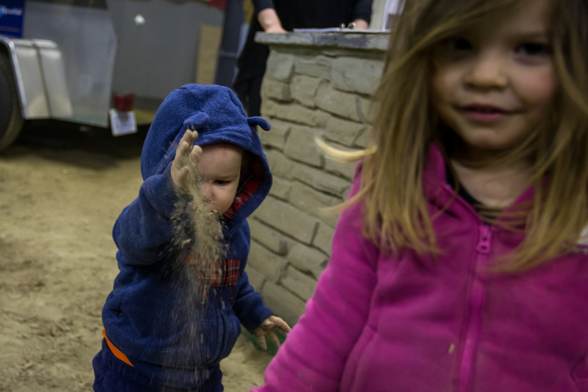  David Makowski, 1, throws dirt while playing with his sister Cynthia, 3, at The Home, Garden and Lifestyle Show at the Washtenaw Farm Council Grounds on Saturday, March 18, 2017. This year marked the 27th year of the show and hosted over 170 vendors