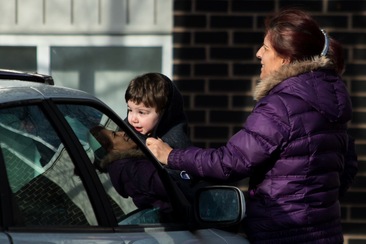  Zuhal Okul, right, stands with Ozgur Okul, 2, outside of their apartment after a fire broke out at Arbor Hills Apartments after a fire broke out on Thursday, March 23, 2017. The cause of the fire is under investigation. Matt Weigand | The Ann Arbor 