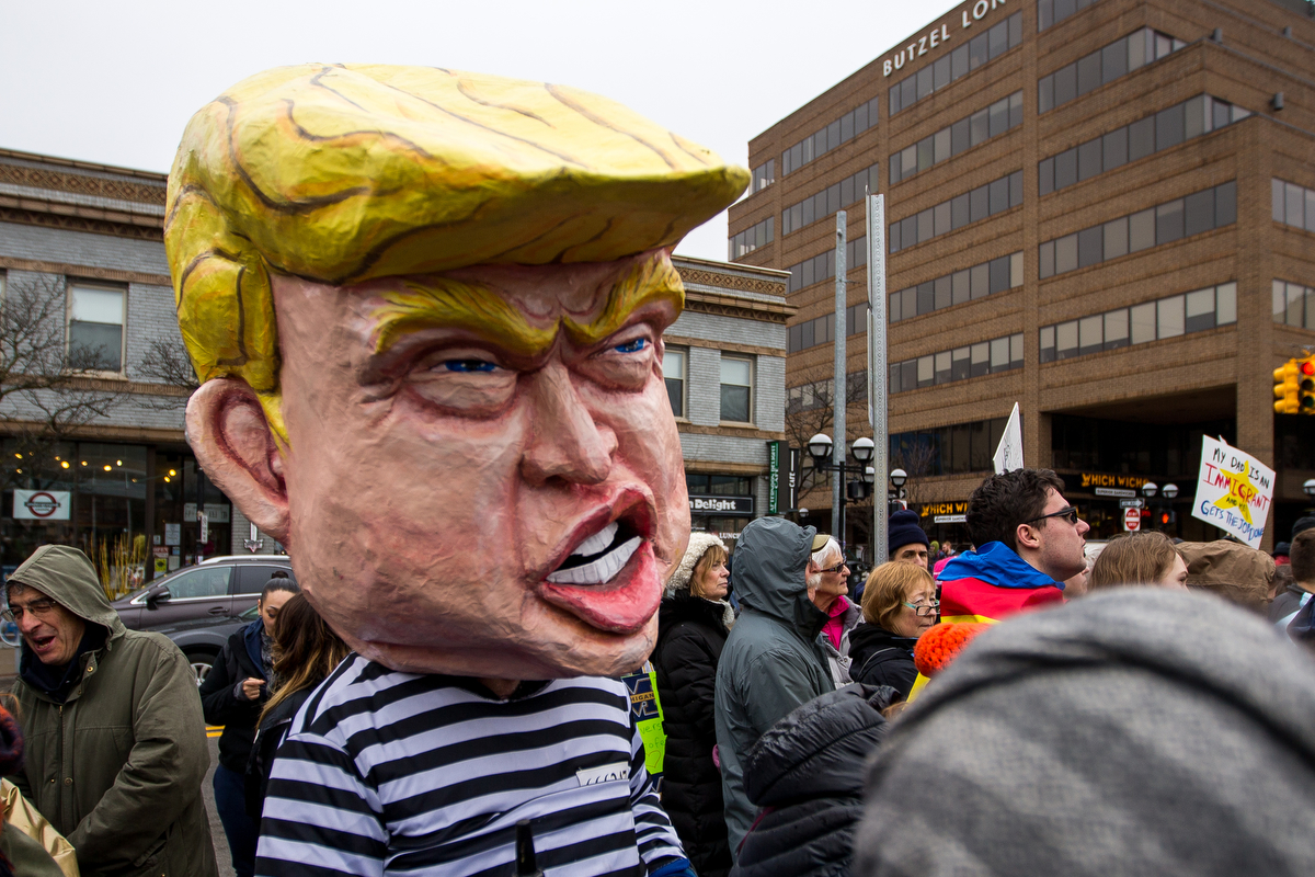  An individual wears a large Donald Trump mask while at the Immigrants' March in downtown Ann Arbor on Saturday, March 25, 2017. Thousands attended the march, which began at the Federal Building and ended at the Diag. Matt Weigand | The Ann Arbor New