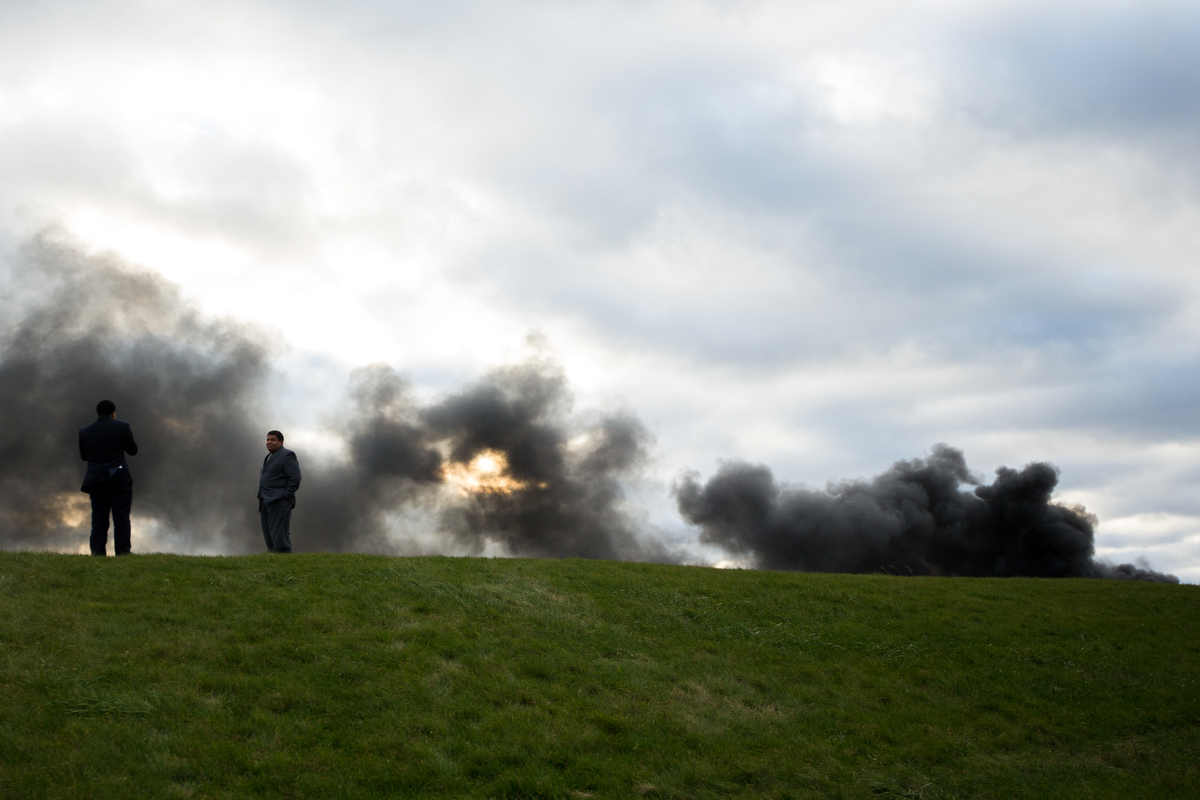  Two men stand atop a hill overlooking GLR Recycling Solutions near Salem Township where a fire at the recycling plant broke out on the afternoon of Sunday, November 20, 2016. Multiple fire departments have responded and there is not yet a cause for 