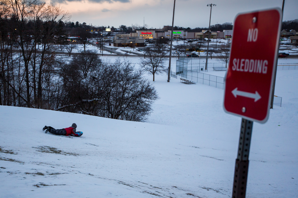  A young boy sleds down a hill at Veterans Memorial Park on Monday, December 12, 2016.&nbsp; 