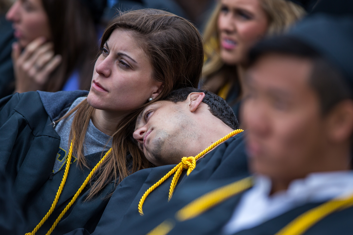  Two graduates rest their heads on each other during the 2017 University of Michigan spring commencement at Michigan Stadium on Saturday, April 29, 2017. Matt Weigand | The Ann Arbor News 