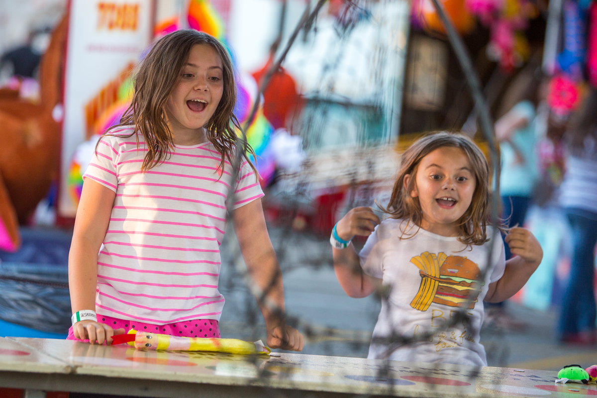  Kate Heller, 10, left and her sister Julianne, 7, celebrate after winning a prize during the opening day of the Ann Arbor Jaycees Carnival at Huron high School on Wednesday, June 21, 2017. The carnival runs from Wednesday to Sunday and over 30 rides