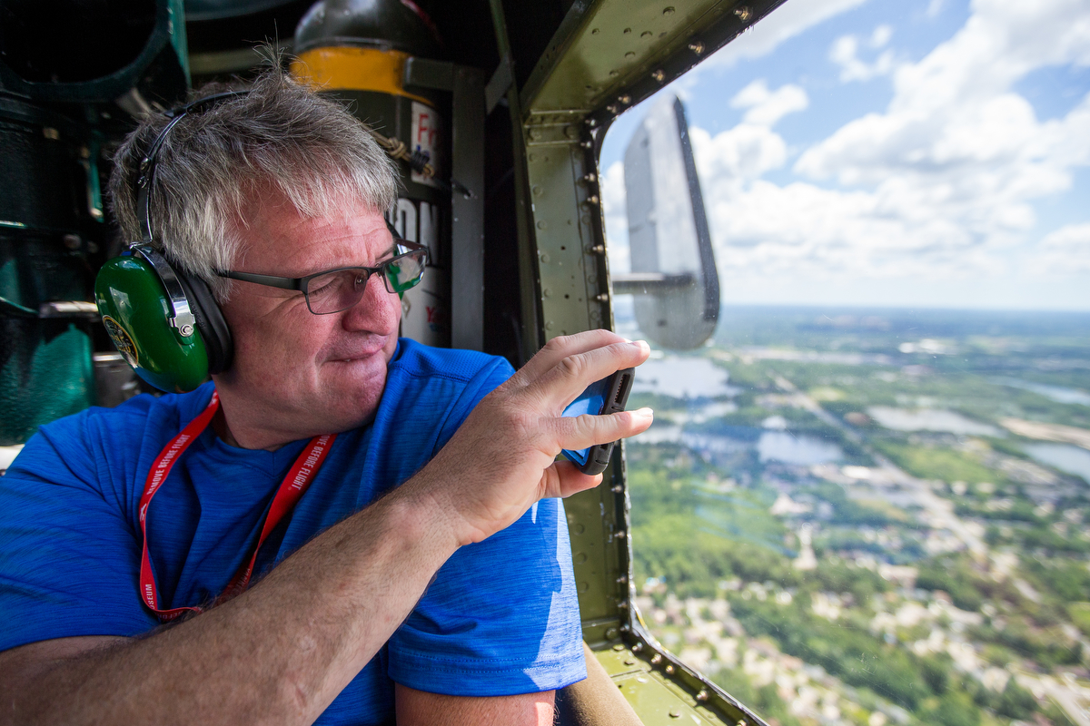  An individual takes a photograph from a window in a 1945 B-25 Mitchell Bomber on Saturday, June 24, 2017. StoryPoint Senior Living in Saline surprised their 99-year-old resident George Lusko with his dream of flying in the B-25. Lusko and his unit i