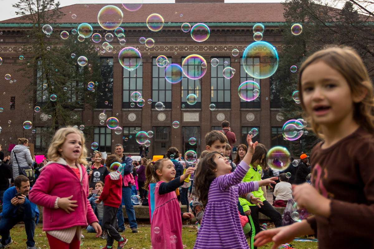 Kids play with bubbles during the Women's March at the Diag on Michigan's campus on Saturday, January 21, 2017.  The march was one of several throughout the country and drew over 6,000 people. Matt Weigand | The Ann Arbor News 