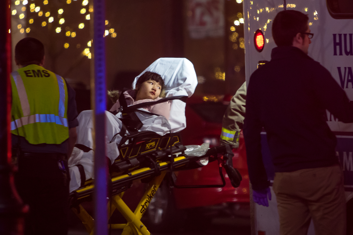  An 8-year-old is carried in a stretcher by EMS after being struck by a USPS truck while crossing Ashley Street at Washington Street with her family. Ann Arbor Police say the 8-year-old suffered minor injuries and the incident remains under investiga