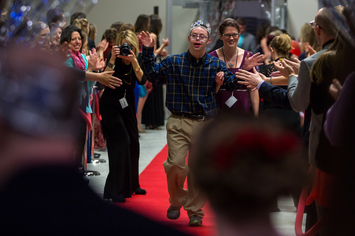  A prom attendee walks down the red carpet and high fives volunteers at 2 | 42 Community Church for the Night to Shine on Friday, February 10, 2017. Night to Shine, sponsored by the Tim Tebow Foundation, is a special needs prom for anyone aged 14 and