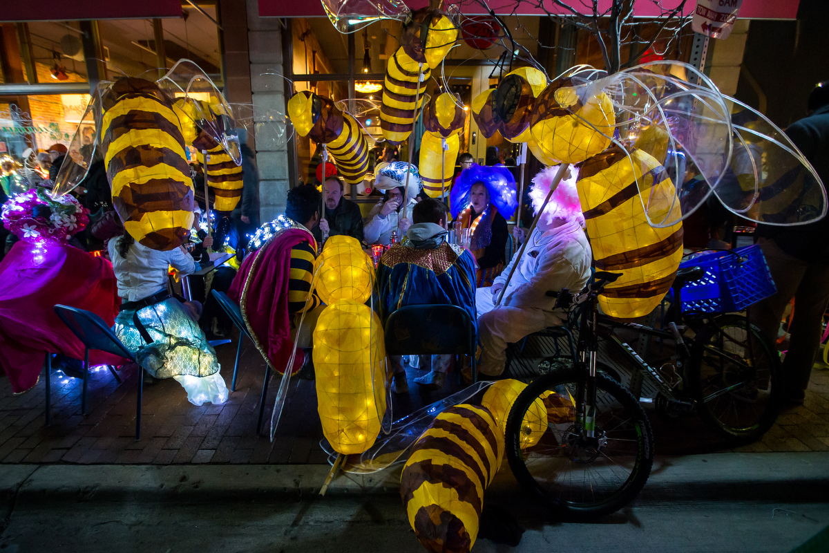  A group of people sit down to eat with their bee luminaries during the FoolMoon gathering on Friday, April 7, 2017. FoolMoon, part of a weekend of events, features beer gardens, music, art installations and luminaries made by hundreds in the crowd. 