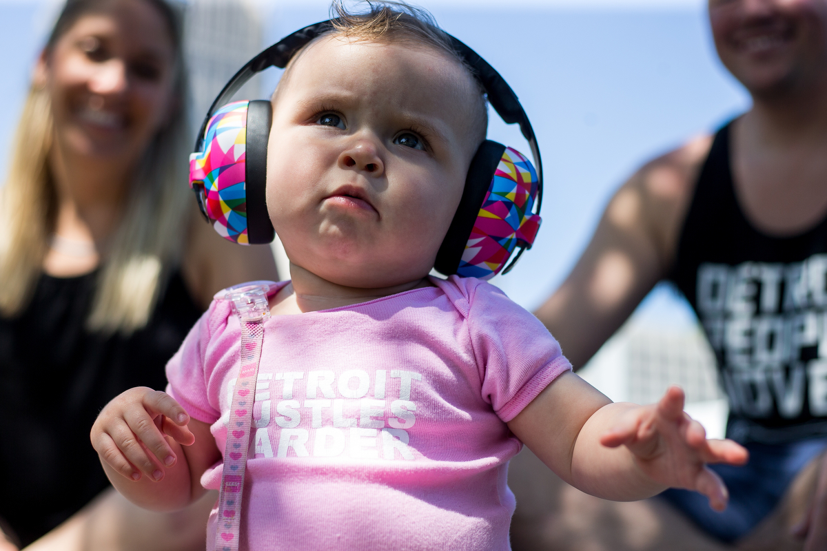  Charlotte Slack, 10-months-old, sits on the grass with her parents Julie, left and Jimmy at Hart Plaza in downtown Detroit for day one of Movement Electronic Music Festival on Saturday, May 27, 2017. Over 100 artists are scheduled to perform over th
