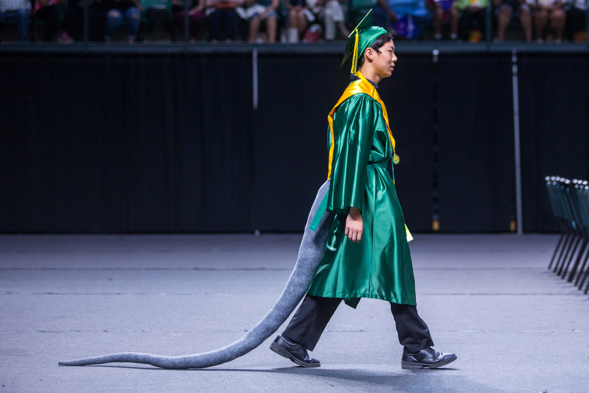  Huron High School student Richard Zhao wears a rat tail during his graduation at the Eastern Michigan University Convocation Center in Ypsilanti on Wednesday, June 7, 2017. 316 students accepted their diplomas and ended their high school careers. Ma