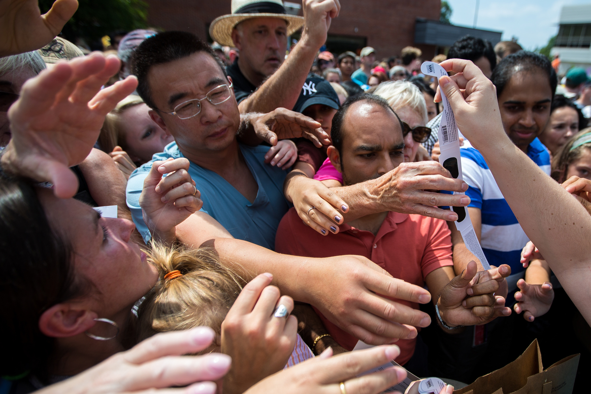  People push and fight to get one of 400 pairs of solar eclipse viewing glasses that were handed out at the Ann Arbor District Library ahead of the solar eclipse on Monday, August 21, 2017. The eclipse began at 1:02 p.m. and hit its max at 2:26 p.m. 