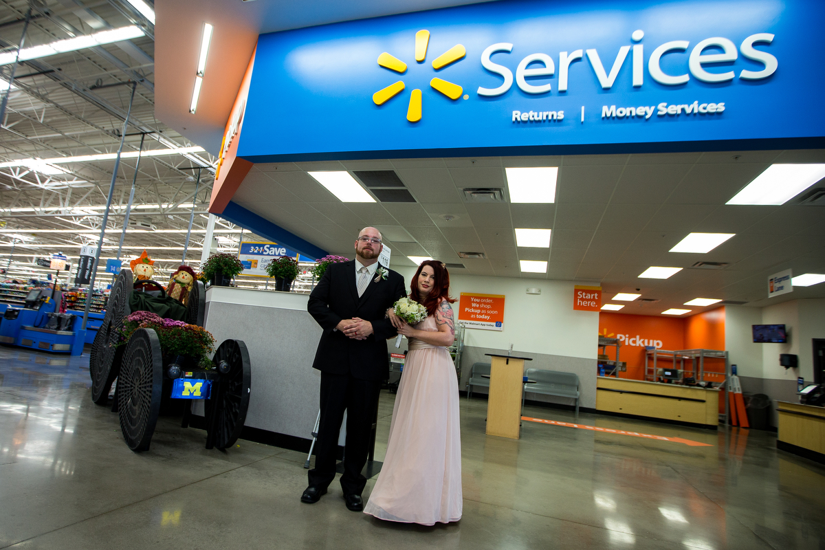  David Medford, left, poses with his wife Marissa after their wedding at the home and garden patio at Walmart in Saline on Sunday, September 24, 2017. Medford met his wife Marissa while working at a Walmart in Guilford, Connecticut about four years a