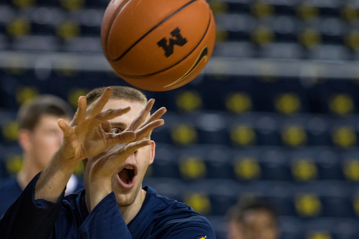  Michigan�s Austin Davis (51) passes the ball to a teammate while warming up before tip-off for the University of Michigan Armstrong State basketball game at the Crisler Center on Friday, November 4, 2016. Matt Weigand | The Ann Arbor News 